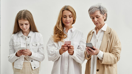Grandma with mother and child using smartphones