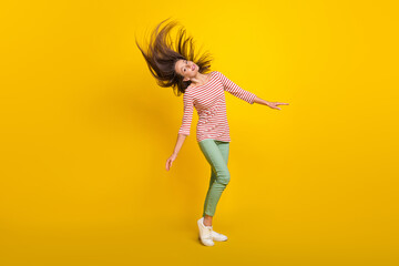 Fototapeta na wymiar Photo of shiny pretty young woman wear striped shirt smiling dancing isolated yellow color background