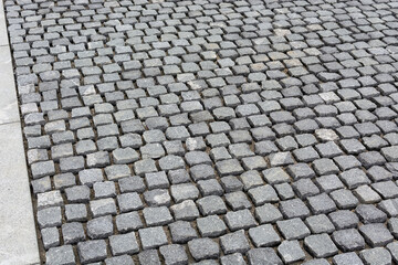 street paved with setts, visible gaps, under construction