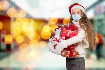 Portrait of adult woman shopping in mall wearing a mask, coronavirus concept