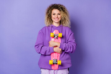Photo of dreamy cute lady dressed hoodie embracing longboard isolated purple color background