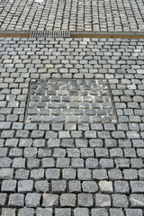 visible gaps, street paved with granite setts, construction site