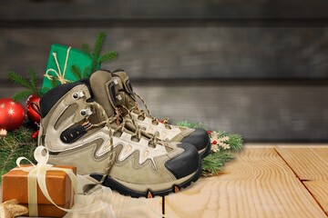 Old hiking boots filled with sweets, and Christmas decoration on Nicholas day,