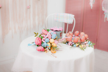 Easter eggs and cakes on a light background