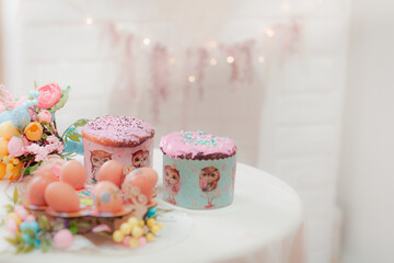 Easter eggs and cakes on a light background