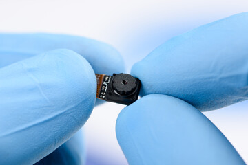 Camera module in scientist hands.