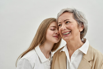 Pleased caucasian girl and her senior grandmother
