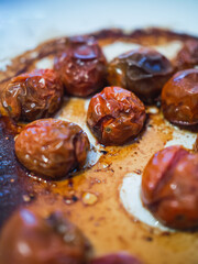 Delicious roasted cherry tomato on white dish. Mediterranean food
