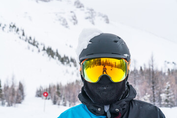 Fototapeta na wymiar Skier man portrait in safe ski equipment