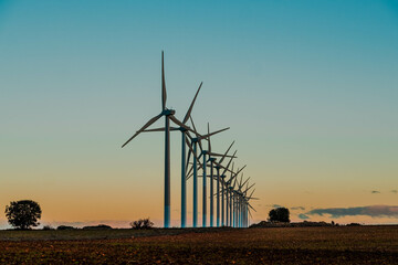 Windmills at dawn at the Cuesta Colorada wind farm in Tébar. LaMancha, Spain.