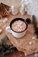 background image with Christmas decor and a cup of cocoa with marshmallows