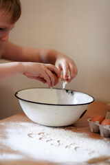 The child's hands prepare the dough