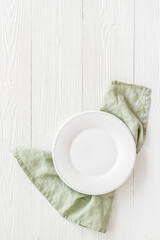 Table setting top view. Empty plate on napkin - dishware for dinner