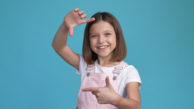 Crazy schoolkid make hands snapshot tongue out isolated blue color background