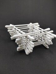 Photo of a pile of cotton buds isolated on a black background