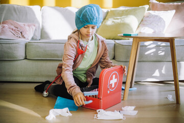 Focused female veterinarian with first aid kit in living room