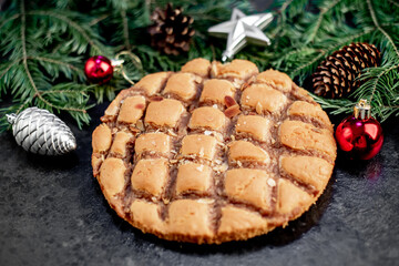 Christmas apple pie
 with fir and new year decorations on a stone background