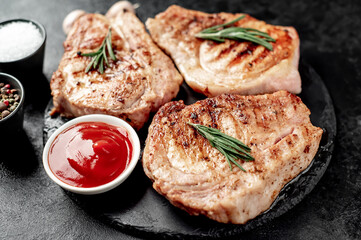 grilled pork steaks on stone background
