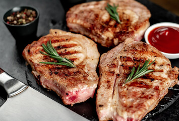 grilled pork steaks on stone background