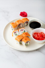 Philadelphia sushi roll with salmon, tuna, avocado, cream cheese and soy sauce