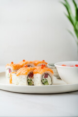 Close up of Philadelphia sushi roll with salmon, tuna, avocado, cream cheese