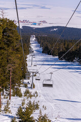 snowboarder is jumping with snowboard from snowhill. Skier skiing downhill in high mountains. Flying skier on mountains, winter extreme sport. 