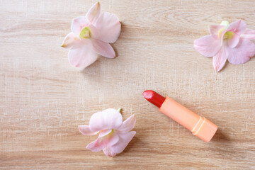Obraz na płótnie Canvas lipstick with beautiful flowers