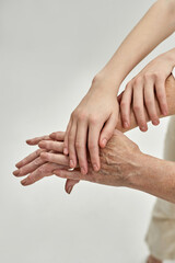 Fototapeta premium Grandma and granddaughter holding hands each other