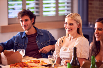 Multi-Cultural Group Of Friends Enjoying Beer And Pizza Party At Home Together