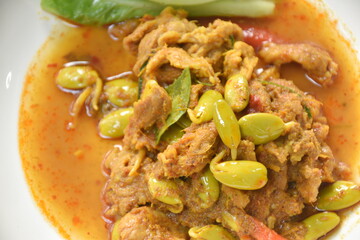 spicy stir fried twisted cluster bean with slice pork and cos lettuce on dish