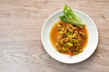 spicy stir fried twisted cluster bean with slice pork and cos lettuce on dish