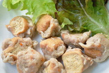 steamed Hakka meatball made from chop pork stuffing fried tofu with fresh vegetable on plate dipping spicy chili sauce