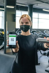 Fototapeta na wymiar Fitness,sports.fit,Girl in mask fitness gym opening lockdown covid passport,QR cod Wellness, health care,generation z sports recreation concept online fitness apps. workout,training,Fit wellness