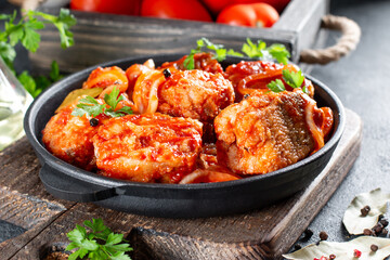 Close up deep fried grouper fish spicy sweet and sour sauce.