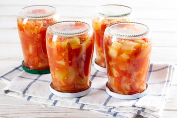 Colorful salad of mixed vegetables in jars ready for winter. Homemade food.