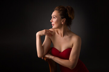 Obraz premium portrait of a sensual fifty year old woman on grey studio background