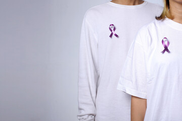 People wearing purple violet ribbons for cancer awareness