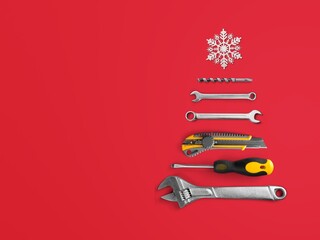 Christmas tree made of construction tools with a snowflake on a background. New Year's concept for...