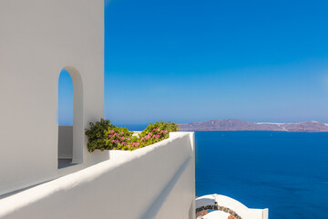 Idyllic travel background, Santorini urban street landscape. Flowers and white architecture under...