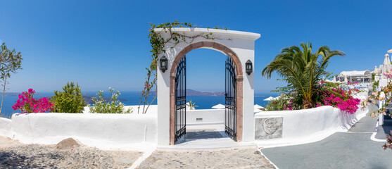 Fantastic travel panorama, Santorini urban street landscape. Blue door or gate stairs and white...