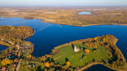 Top view of fall forest and lake. Autumn sunny evening over a forest lake.