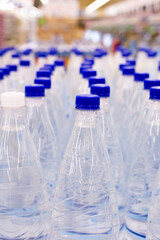 water bottles with blue caps in supermarket