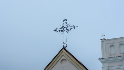 Close-up of the Catholic cross on the gate at the entrance to the church. The concept of worship and faith in God.