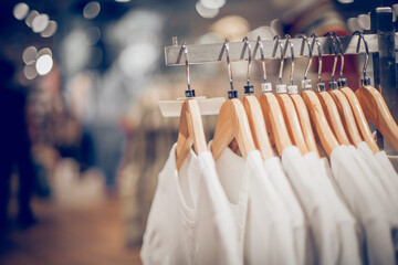 T-shirts on hangers. Shopping in store. Clothes on hangers in shop for sale