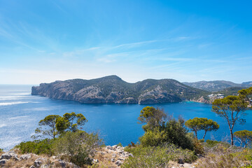 Panoramic of the bay of Camp de Mar, Mallorca. Blue Mediterranean sea and sky. Pine trees around and boats in the sea.