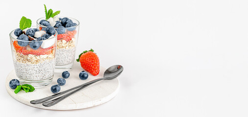 Chia seed yogurt pudding with berries, coconut and mint. Healthy eating and superfoods concept. Copy space
