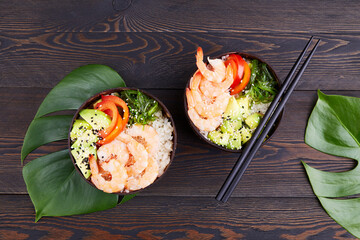 Shrimp poke bowl with fresh prawn, rice, pepper, chuka seaweed with black and white sesame. Fresh seafood recipe.