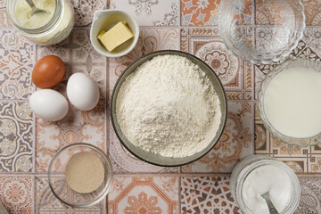 Baking ingredients for dough - white flour, eggs, milk, yeast, sugar, salt