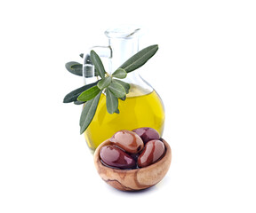 Red olives on white background with oilive oil closeup. Olives Kalamata with leaves in wooden bowl.