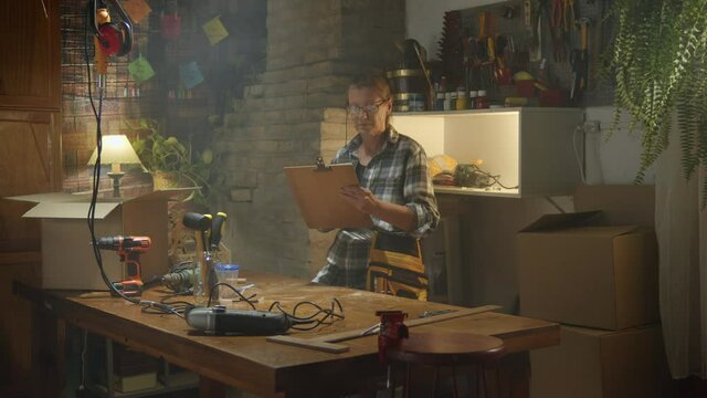 Mature woman carpenter checking orders on a paper list